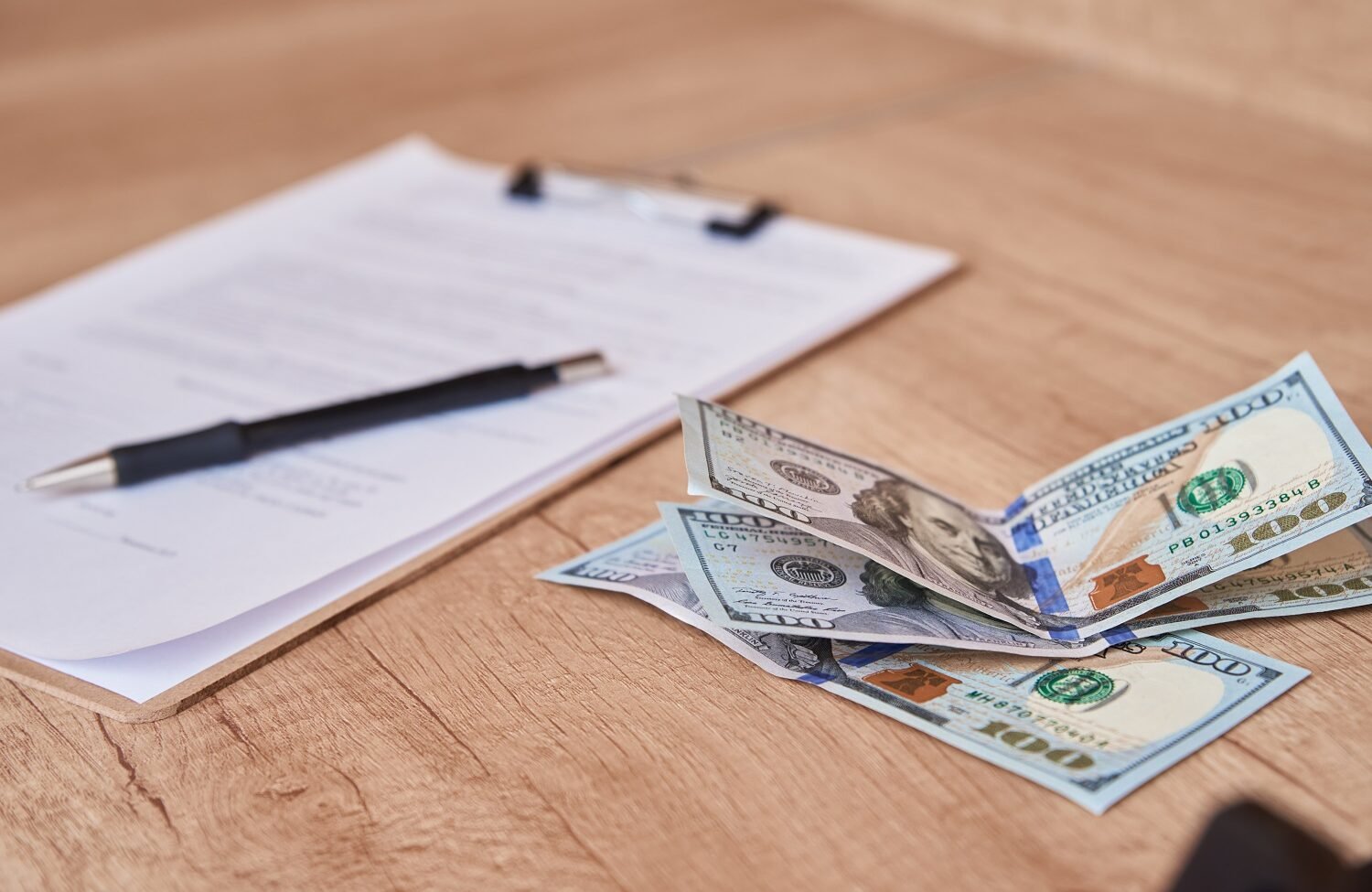 document pen and dollar bills on table close up RYP4FAF Hotel Paradise DLX