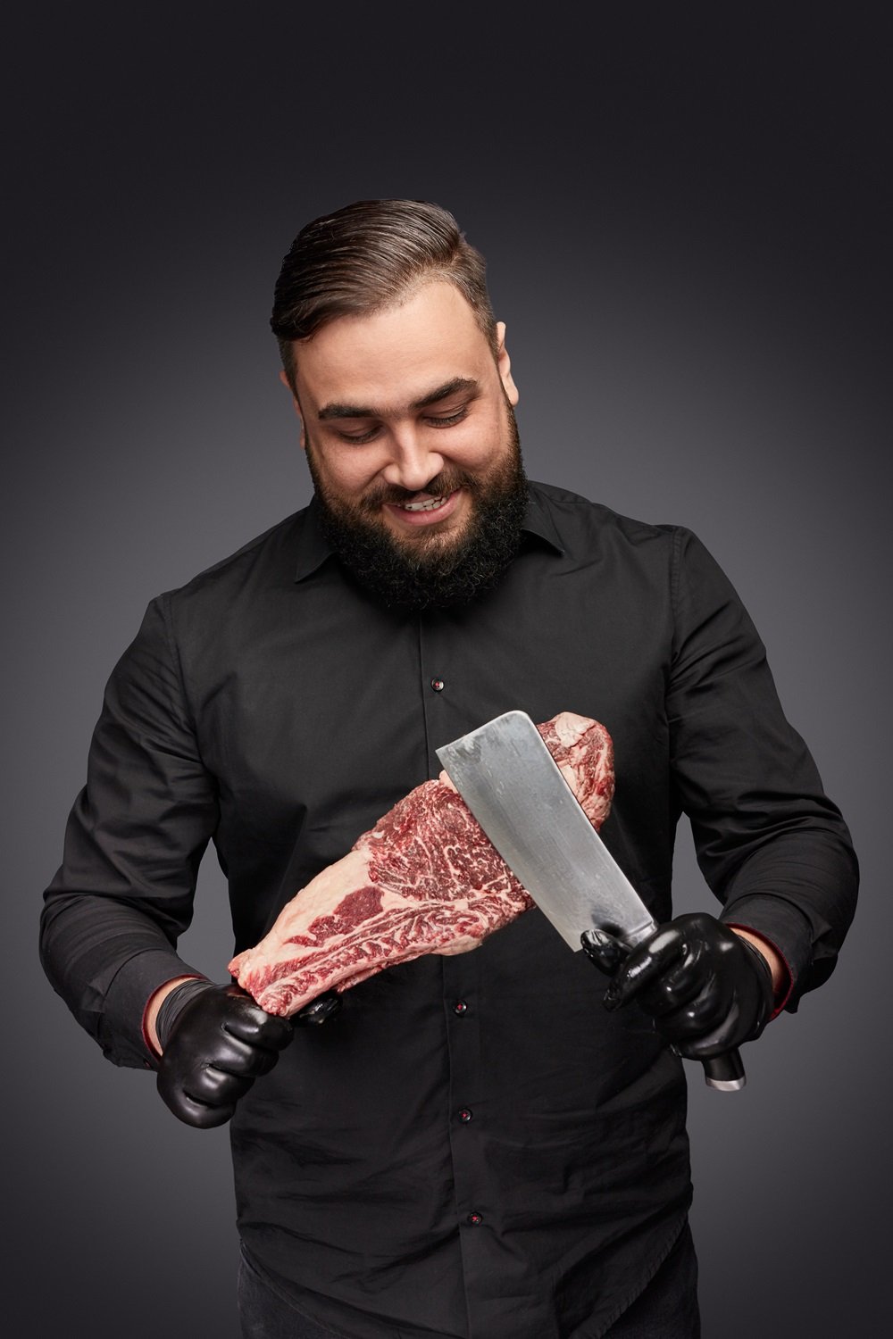 Smiling Butcher Scratching Meat With Knife FD5WRHN