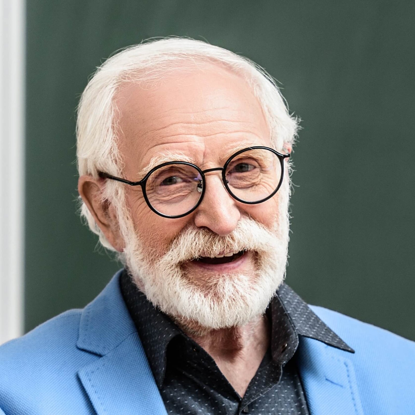 smiling grey hair professor holding paper plane in 2023 11 27 05 19 03 utc Cropped Hotel Paradise DLX